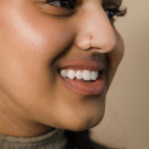 Marked with a spiraling pattern, this nose hoop offers a simple and timeless addition to your wardrobe that you never have to take off. Made to wear without a piercing, this piece can comfortably be a part of your wardrobe every day.Materials &... Gold Nose Piercing Hoop, Nose Ring On Big Nose, Right Nose Piercing, Nose Ring Without Piercing, Nose Ring Aesthetic, Girls With Nose Rings, Nose Piercing Gold, Ring Nose Pin, Gold Nose Ring Hoop