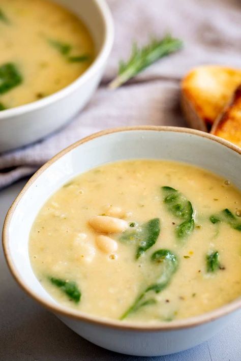 This Creamy Tuscan White Bean Soup is easy to make and packed full of the flavors of Tuscany. Soup and crusty bread is the ultimate comfort food, and this bean soup is so easy to make! With a few tins of beans, rosemary, garlic, and parmesan, you can have a creamy bean soup that is packed with flavor and ready in under 20 minutes! The perfect meal for winter, this soup tastes delicious but is remarkably healthy, with a smooth, creamy texture without the need to add heavy cream! Tuscan White Bean Soup, Butter Bean Soup, Cannellini Beans Recipes, Chicken Fried Chicken, Tuscan White Bean, Bean And Vegetable Soup, Tuscan Bean Soup, White Bean Soup Recipes, Rosemary Garlic