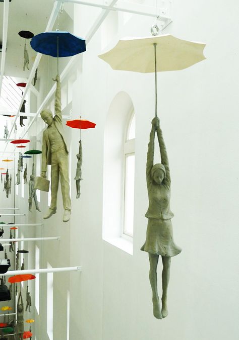 These cement figures dangling from umbrellas within a narrow space inside the EBC office center in Prague are part of a installation titled Slight Uncertainty by Czech artist Michal Trpák. Check out much more of his sculptural work on his website. Umbrella Art, Sculptures Céramiques, The Ceiling, Sculpture Installation, Land Art, Public Art, Art Plastique, Art Sculpture, Ceramic Sculpture