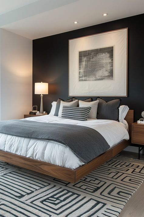 Modern bedroom with a black accent wall behind the bed, featuring a large framed artwork, bedside tables, and soft lighting, emphasizing sleek decor. Accent Walls Bedroom, Dark Modern Bedroom, Charcoal Bedroom, Brown Accent Wall, Dark Accent Walls, Modern Bedroom Ideas, Black Accent Walls, Masculine Bedroom, Minimal Bedroom