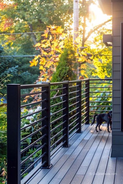 If you want something simpler, horizontal black steel railing will make your deck look sharp and sophisticated. Railing Deck Ideas, Back Porch With Railing, Black House With Decking, Black Porch Railing, Back Deck Railing Ideas, Outdoor Deck Railing Ideas, Porch Deck Ideas, Black Deck Railing, Modern Deck Railing Ideas