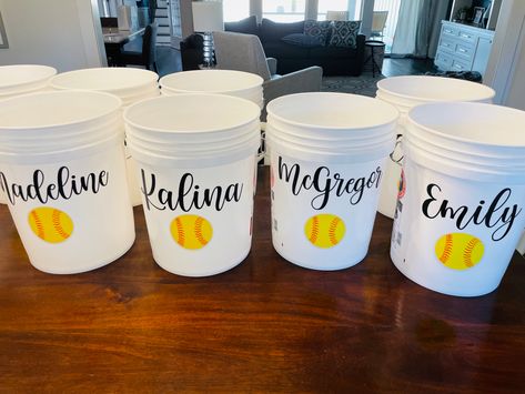 Softball Buckets Ideas, Softball Dugout Ideas Team Mom, Dugout Mom Ideas, Softball Buckets, Dugout Organization Softball, Softball Dugout Organization, Softball Baskets For Dugout, Softball Dugout Buckets, Wagon Floats Ideas Kids