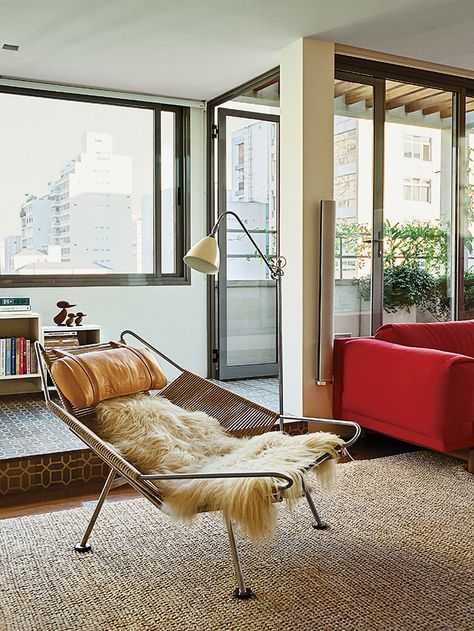 A Flag Halyard chair by Hans Wegner in long-haired sheepskin occupies one end of the living room. Hans Wegner Furniture, Halyard Chair, Bryan Ferry, Dwell Magazine, Futuristic Furniture, Casa Container, Hans Wegner, Chair Style, Cool Chairs