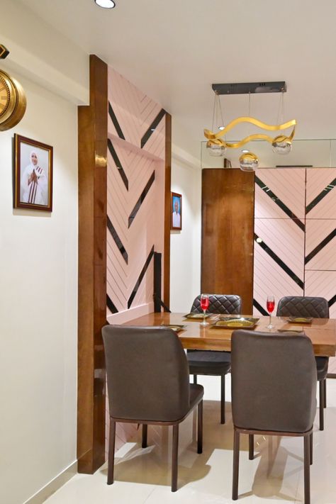 Dining area is kept simple and clean to maximise the use of the space. The dining table is kept foldable for the same. To accommodate a big storage and to maintain design aesthetics we have used veneer and grooved MDF in duco finish with black mirror stripes on storage doors. A beautiful art frame of horse catches the eye of visitor. Dining Wall Design, Duco Finish, Wall Dining Table, Living Room With Dining Area, Roof Terrace Design, Crockery Unit Design, Foldable Dining Table, Dining Table Design Modern, Creative Office Space