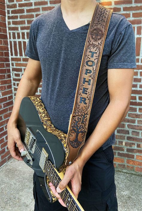 Quality leather hand-engraved guitar straps personalized with your name and custom artwork at BurnWizard.com - Western country scrollwork, Celtic cross, nature scenes - anything goes! This Italian glove leather guitar strap features a "Tree of Life" design with Celtic cable braid patterns, pictured here with the BurnWizard custom "Black Jack Tele" guitar with hand carved paisley scrollwork binding #customguitarstraps #paisley #scrollwork #celtic #treeoflife #guitarstrap #personalizedguitarstrap Leather Tooled Guitar Strap, Custom Leather Guitar Straps, Custom Guitar Strap, Leather Guitar Strap Pattern, Leathercraft Ideas, Acoustic Guitar Strap, Custom Leather Work, Leather Guitar Strap, Wonderful Husband