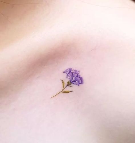 The Meanings Of Carnation Tattoos (Explained In Detail) Flower Symbolism Tattoo, Carnation Wrist Tattoo, Tiny Carnation Tattoo, Purple Carnation Tattoo, Carnation And Marigold Tattoo, Small Carnation Tattoo, Flower Tattoo Ear, Carnation Tattoos, Watercolor Wrist Tattoo