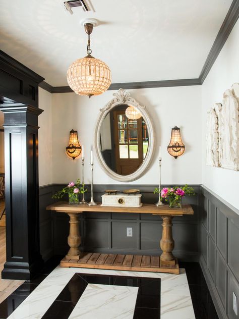 Sara's tastes run toward a nouveau classical look with an affinity for ornate furnishings and French antiques. The combination presented a decorating challenge for Joanna who frequently leans more in the direction of farmhouse country and rustic themes. This new foyer – highlighted by black and white marble floors, rich textures and dark gray paneling – offers a mix of contemporary elements and old world touches making for a carefully integrated look that marries comfort and style. Farmhouse Foyer, Hgtv Fixer Upper, 70s House, White Marble Floor, Latest Interior Design Trends, Interior Design Per La Casa, Decor Videos, Decor Ikea, Home Luxury