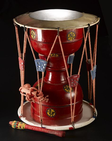 Drum beater of wood, wrapped in red nylon with green and yellow decoration at one end, used with a jeongak jango (hourglass drum) to lead the rhythm of ritualistic proceedings, part of the Korean Shaman Collection: Korea, 1960s Korean Shaman, Korean Instruments, Metamorphosis Art, Yellow Decor, Drummer Boy, Japanese Characters, Red Lacquer, Cow Skin, Weird Shapes