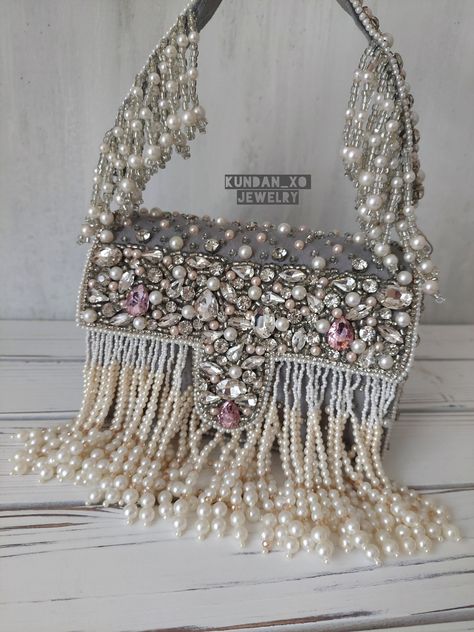 -STONE HANDBAG-  Regal designer clutch with heavy hand embroidery is sure to turn heads! Elegantly embellished with pearl tassels and stone work in beautiful cool tones on a matte grey base. Fully stitched with hand embellishments all over. Indo-western handbag comes with removable shoulder chain so can be worn multiple ways!  PERFECT clutch sized to fit  phones and accessories in style! Makes a great gift too! Our beautiful Indo-western design done in our most versatile shade is sure to add the Return Gifts Indian, Pearl Tassels, Bridal Clutches, Indian Wedding Gifts, Velvet Handbag, Indian Wedding Favors, Western Handbags, Bridal Handbags, Bridal Purse