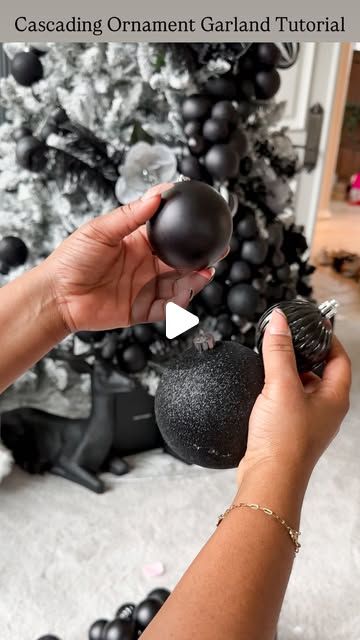 Tina Meeks on Instagram: "How to create Cascading Ornament Garland + Luxe Design Tree Look...  SAVE this for inspiration for decorating your Christmas tree. You’ll need floral wire + ornaments of different sizes and some patience. I went with black but it’ll look amazing in any color.   I used 15-20 ornaments per cluster. About 8 full clusters on this 7.5 foot tree. Be sure to double loop the first and last ornament or they’ll slide all over the place. Happy Decorating!!🖤" Black Blue Christmas Tree, Cascade Ornaments On Tree, Grouping Christmas Balls On Tree, Bulb Cluster On Tree, Cascading Christmas Ornaments, Flocked Tree With Black Ornaments, Christmas Tree Ornament Garland, Bauble Cluster On Tree, Cascading Ornaments On Tree