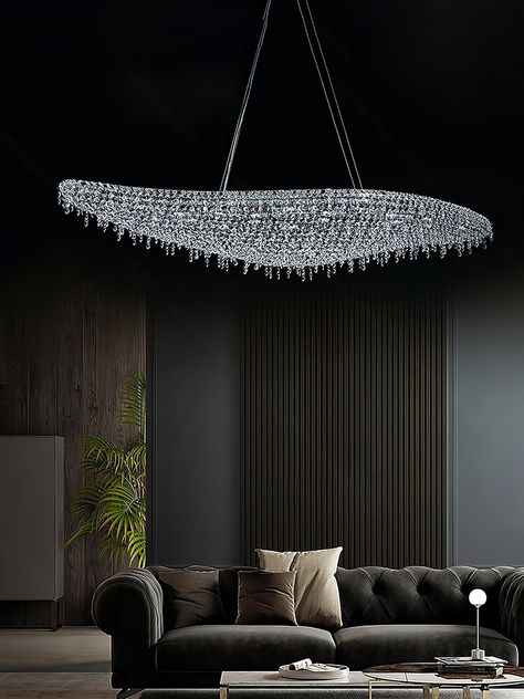 The Boat Crystal Chandelier is an epitome of modern sophistication and a true testament to craftsmanship in contemporary lighting design. With its sleek, boat-like silhouette, this chandelier captivates with a wave of shimmering crystals, carefully suspended from a durable metal and aluminum frame. 
 Embodying luxury and grace, the chandelier's elongated form stretches across the space like a vessel on a tranquil sea of light. The carefully selected crystals are meticulously arranged to catch and reflect every beam, emitting a spectrum of radiant, sparkling light that dances across the room. Its grand presence is both an illuminator and a centerpiece, perfect for gracing the overhead space of dining areas, grand entrances, or high-ceilinged living rooms. 
 This Boat Crystal Chandelier is m Modern Luxury Lighting, Grand Entryway, Contemporary Lighting Design, Hall Lighting, Tri Colour, Sparkling Lights, Luxury Dining Room, Luxury Lighting, Chandelier In Living Room