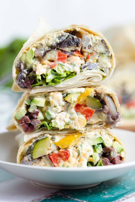 If you're looking for a vegetarian lunch or light dinner, try this Mediterranean Veggie Wrap! It's made with mashed chickpeas with tangy tzatziki sauce, creamy hummus, roasted colorful veggies, and fresh lettuce. This wrap is super versatile so you can add things or leave them out based on your preference. It's delicious any time of the year whenever you want to add some extra veggies to your diet! Mediterranean Veggie Wrap, Mediterranean Wrap Recipes, Mashed Chickpeas, Mediterranean Wrap, Veggie Hummus Wrap, Peach Banana Smoothie, Veggie Wrap, Lemon Smoothie, Colorful Veggies