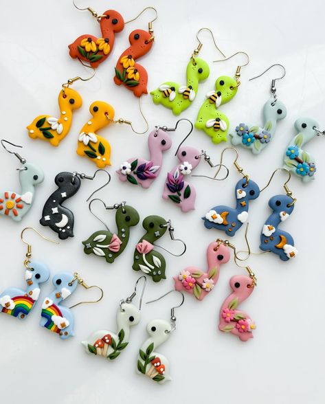 DINO earrings are coming back!! if u swipe u can see all the designs that’ll be available in bronto and stego options🥰 all the dinosaur earrings, dropping this saturday 6.22 at 1PM pacific ! what do u think do you see any that u like🥺♥️ ?? Dino Earrings, Dinosaur Earrings, Clay Pendants, U Can, Jewelry And Accessories, Dinosaurs, Canning, Quick Saves, Design