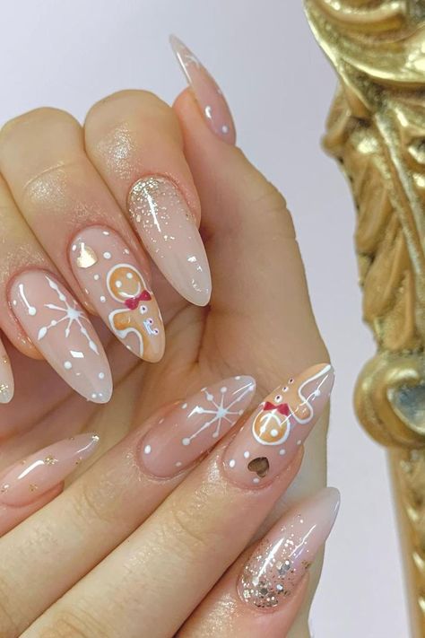 Gingerbread Sweetness: Soft pink almond nails adorned with adorable gingerbread man art and delicate snowflake designs create a holiday masterpiece that sparkles like fresh snow! // Photo Credit: Instagram @simplybeauty_bridgend Trendy Christmas Nails, Press On Acrylic Nails, Nails Festive, Snow Nails, Nails Nude, Cute Christmas Nails, Christmas Nails Acrylic, Hot Nails, Xmas Nails