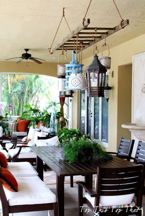 Create a warm, eclectic look on a porch or patio by using a ladder as frame to hang lanterns of various shapes, colors, and heights. Old Wooden Ladders, Lanterns Hanging, Koti Diy, Old Ladder, Shabby Chic Garden, Wooden Ladder, Patio Lighting, Outdoor Dining Area, Outdoor Rooms