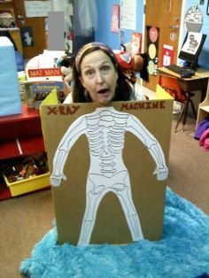 Here's me in our class xray machine.  Provide gloves, masks, and stuff to play doctor. The skeleton is hand drawn to fit the card board. Hospital Theme Preschool, Xray Machine, Doctor Role Play, Dramatic Play Themes, Play Doctor, Community Helpers Theme, Role Play Areas, People Who Help Us, Dramatic Play Preschool