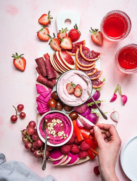 This Pink Snack Board is the perfect appetizer for Valentine's Day! Filled with healthy snacks like beet hummus, strawberries, grapes, raspberries and apples, it's both nourishing and SO pretty! #noshandnourish #pinksnackboard #valentinesdayrecipes #valentinesdayappetizers Pink Foods For Party Healthy, Pink Cheese Board, Healthy Pink Snacks, Healthy Pink Food, Pink Healthy Food, Pink Appetizers, Hummus Board, Pink Hummus, Pink Snacks