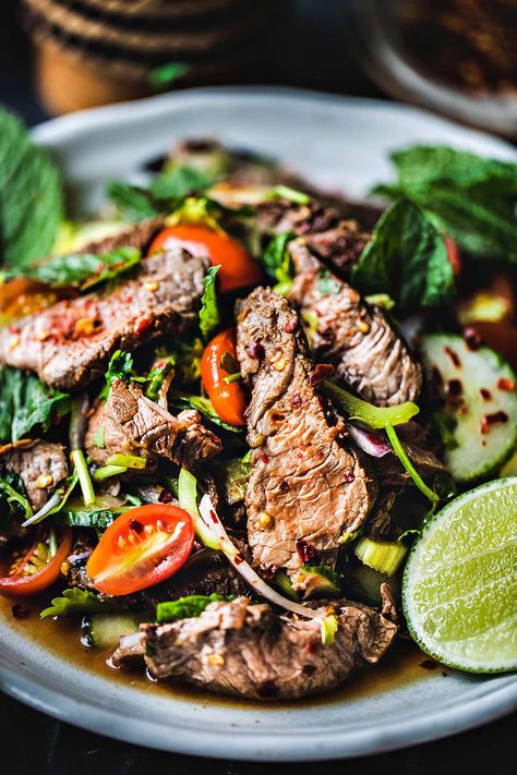 This easy Thai beef salad recipe has fresh summer vegetables, fragrant herbs, lime juice, and fish sauce. Once you gather all your Thai beef salad recipe ingredients, you’ll eat a tasty meal in less than 30 minutes! #thaibeefsalad #thaibeefsaladrecipe #easythaibeefsalad #spicythaibeefsalad #thaibeefsaladrecipes Thai Beef Salad Recipe, Thai Salad Recipes, Round Steak Recipes, Thai Beef Salad, Spicy Salad, Tasty Thai, Thai Beef, Thai Salads, Summer Vegetables