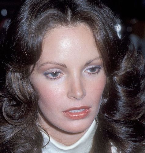 Close-up of Charlie's Angels actress Jaclyn Smith from 1978. She is wearing subtle light blue eyeliner, warm pink blush, and peach lipgloss. Her brunette hair has a 1970s feathery look and is curled away from her face. She is wearing a high neck white silk blouse. Charlie S Angels 70s, Bug Photoshoot, 1970 Makeup, Charlie's Angels 70s, Charlie S Angels, 1970s Makeup, Angel Makeup, 70s Makeup, 80s Makeup