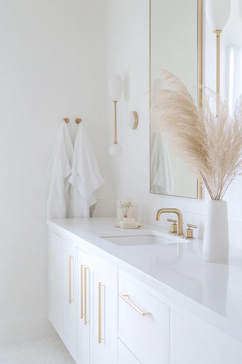 Discover modern bathroom ideas that elevate your space with elegance and simplicity. This design features clean lines, minimalist fixtures, and a soothing color palette. Perfect for a fresh and stylish update! #ModernBathroom #HomeDesign #InteriorDecor Simple Chic Bathroom, White And Gold Half Bath, Sisters Bathroom Ideas, White Mid Century Bathroom, Modern Simple Bathroom Design, White Gold Bathroom Ideas, White Bathrooms Modern, White Clean Bathroom, White And Bronze Bathroom