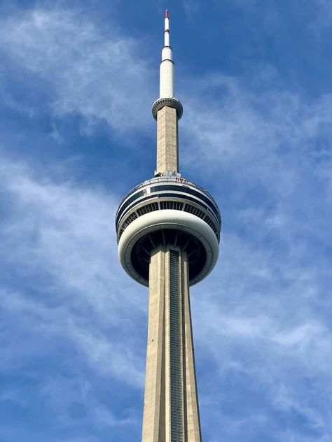 View of the top of the CN Tower against a blue sky. Guests on the Edgewalk are also visible. Cn Tower Restaurant, Blue Jays Game, Toronto Hotels, Toronto Island, Toronto Skyline, Gift Towers, Toronto Travel, Downtown Toronto, Lake Ontario