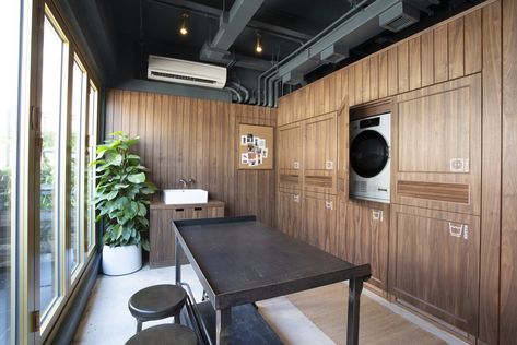 Dwell - This Hip Hong Kong Apartment Building Nails Small Space Living Shared Laundry Room, Hong Kong Apartment, Apartment Laundry, Rent Studio, Dorm Style, Modern Laundry, Modern Laundry Rooms, Wood Counter, Apartment Complexes