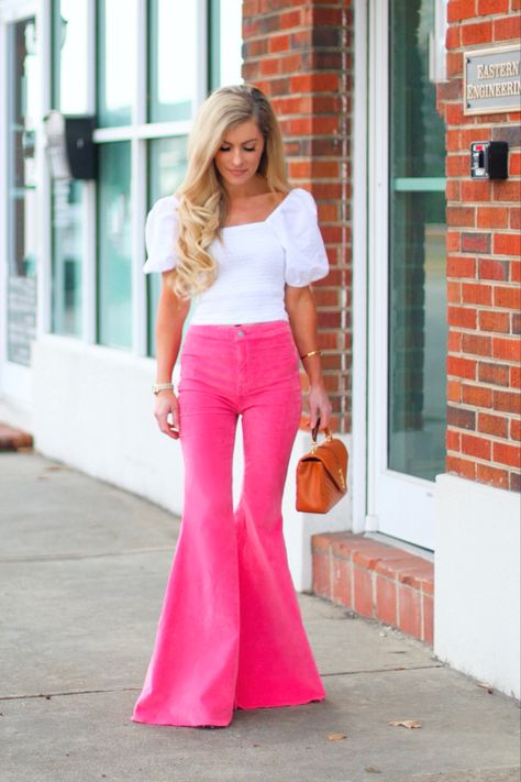 Valentines outfit inspo : The most darling bell flare pink velvet jeans , paried with a white puff sleeve top . Outfit linked to shop the look Pink Bell Bottom Jeans, Pink Bell Bottoms Outfit Western, Hot Pink Bell Bottoms Outfit, Pink Flare Pants Outfit Aesthetic, Hot Pink Flare Pants Outfit, Pink Flare Jeans Outfit, Hot Pink Jeans Outfit, Pink Bell Bottoms Outfit, White Puff Sleeve Top Outfit