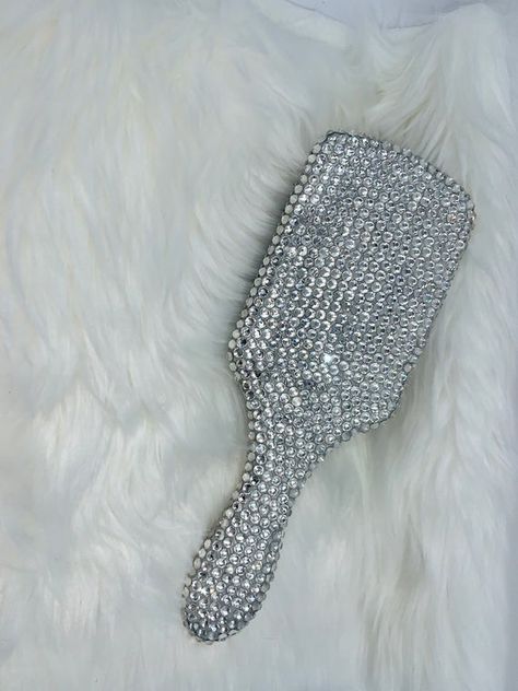 What a great way to give your decor some sparkle!This black and silver hairbrush is covered with clear rhinestones.  Very sparkly and special! I use industrial strength glue for extra security.I have more items in my shop, check it out!https://www.etsy.com/shop/jazziecreations?ref=hdr_shop_menuHave an awesome day! Silver Hairbrush, Bedazzled Ideas, Rhinestone Things, Bedazzle Ideas, Bedazzled Things, Hannah Marin, Bedazzled Stuff, Custom License Plate Frames, Bling Ideas