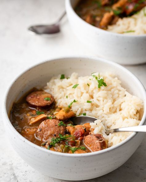 This easy and healthy Chicken and Sausage Gumbo recipe is Louisiana/New Orleans style made with a dark roux and Cajun flavors. Learn how to make gumbo and how to make a dark roux so you have enjoy this authentic gumbo recipe for an easy weeknight dinner! Be sure to serve with white rice or brown rice on top. It’s also freezer friendly so you can have it on hand for a quick, low carb dinner idea! #gumbo #rice #thinkrice #cajun #neworleans #chickengumbo #sausagegumbo #easygumbo #Louisiana #... Authentic Gumbo Recipe, Gumbo Rice, Authentic Gumbo, Chicken And Smoked Sausage, Chicken And Sausage Gumbo Recipe, Arancini Rice Balls, Sausage Gumbo Recipe, Easy Gumbo, Gumbo Recipe Easy