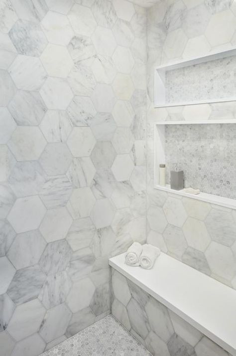 Stunning walk-in shower boasting large marble hexagon wall tiles with a white quartz bench. Hexagon Shower Tile, Large Tile Bathroom, Hexagon Wall Tiles, Hexagon Tile Bathroom, Tub To Shower Remodel, Marble Bathroom Floor, Shower Remodel Diy, Small Shower Remodel, Hexagon Wall