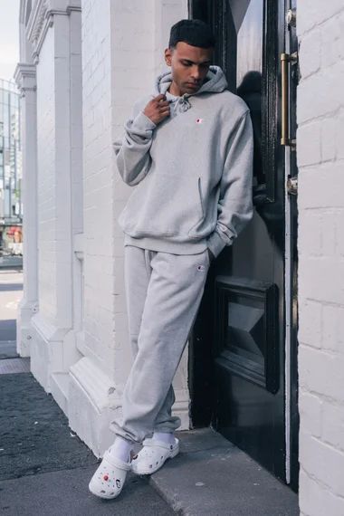 Mens crocs outfit idea for fall and winter! Model is in champion sweatsuit with white crocs! Click the link below to see more colors! Crocks Outfits For Men, Croc Outfits Men, Black Crocs Outfit Men, White Crocs Outfit Men, Crocs Aesthetic Outfit Men, Guys Crocs Outfit, Sweatpants With Crocs, Boys Crocs Outfit, Men’s White Crocs Outfit