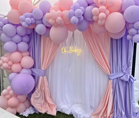 Give your baby shower party ambiance an endearing look and feel by setting up a sweet blush & lavender party backdrop. Set a sturdy backdrop stand and stylishly hang white, blush, & lavender polyester curtain panels to give your party backdrop a charming appeal. Highlight the adorability of your party backdrop by decking it with a blush & lavender balloon garland and hang ‘oh baby’ neon light sign to add funky vibes and festive lights into your baby shower party décor. Lavender Balloon Garland, Lavender Balloons, Lavender Party, Event Decor Ideas, Party Decorations Table, Backdrop Decor, Decorations Table, Baby Shower Backdrop, Neon Light Signs