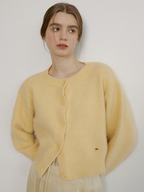 Ivory angora-wool blend cardigan sweater with REORG signature logo in 18k gold. Round neckline, long sleeve, and buttons at front.    - Round neckline- Button closure- Long sleeve Crew Neck Cardigan Knitting Pattern, Butter Yellow Sweater, Collared Cardigan Outfit, Fluffy Cardigan Outfit, German Style Fashion, Wool Cardigan Outfit, Ivory Clothes, Button Up Sweater Outfit, Yellow Cardigan Outfits