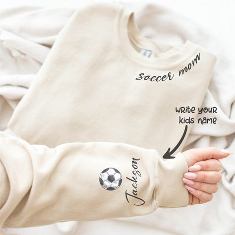 Custom Soccer Mom Sweatshirt, Game Day Hoodie, Champion Mom Gift, Football Sweatshirt, Team Spirit, Team Cheer Mama, Mother's Day Gift Description Due to the nature of the fabric as well as your monitor or mobile screen colors may differ slightly. Our tees and more are handcrafted one at a time. It is therefore very rare to create identical items so you may find minor distinctions that make your SassyPantsTees items special and truly one-of-a-kind. All sales are final. Cancellations, Refunds and Soccer Mom Sweatshirt, Team Cheer, Custom Volleyball, Soccer Stuff, Volleyball Mom, Cheer Team, Cricut Craft, Football Sweatshirt, Name Print