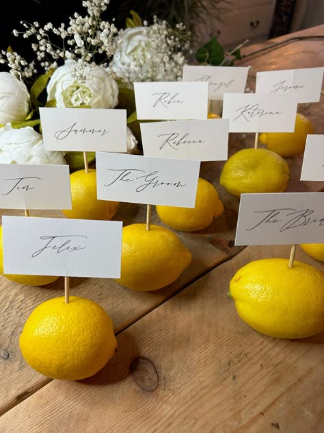 Pretty place cards for each guest. We have used a calligraphy style font used for each guest name. Sleek and simple design ready for you to get creative on your tablescape. We've paired outs with cocktail sticks and lemons but they could be places with menus or flowers. Printed on 300gsm uncoated card and 7.8x4cm in size. Once ordered we'll be in touch and would require an excel or google sheet with the names in. Turnaround is one week + postage time. Please note, lemons and cocktail sticks not Italian Wedding Design, Place Card Ideas Dinner Party, Lemon Place Cards, Italian Theme Engagement Party, Hosting Inspiration, Lemon Table Decor, Personalized Place Cards, Italian Party, Italian Theme