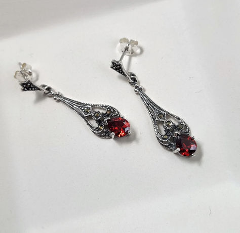 crafted of sterling silver, red glass that shifts from a deep dark red to an orangish hue in the light, and genuine marcasite, these ornate earrings are Victorian inspired and elegant. These are 1 & 3/8" high and 3/8" wide and weigh about 6.8 grams. The red glass stones are 7x5mm. Gothic Dark Academia, Perfume Jewelry, Vintage Inspired Earrings, Clean Sterling Silver, Gothic Earrings, Vintage Inspired Jewelry, Sterling Silver Marcasite, Filigree Earrings, Garnet Earrings