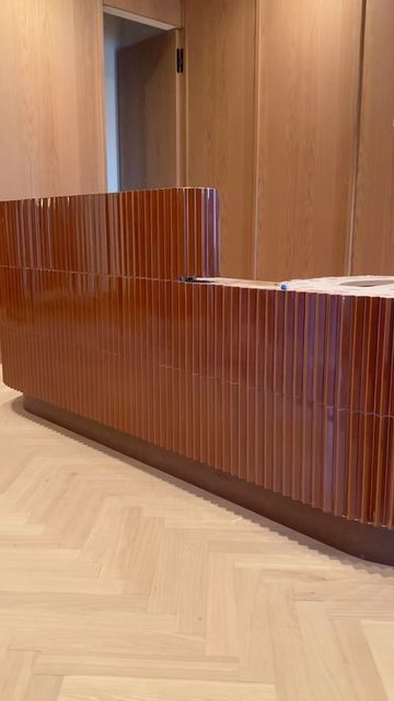 And And And Studio on Instagram: "Soon-to-be stone topped, textured rust tiled reception desk with chrome base (not installed yet) sitting on top of beautiful new oak herringbone floors at our latest commercial design project. #andandandstudio #and2109 . . . . #tile #tiles #custombuilt #tiledesign #tilestyle #tilework #receptiondesk #tileporn #tileinspiration #tilelife #tiletrends #tileslover #construction #commercialdesign #tileideas #inconstruction #centurycity #newofficespace #mutina #mutina Tiled Front Desk, Tiled Reception Desk, Tile Reception Desk, Front Desk Hotel, Lobby Desks, Office Redesign, Herringbone Floors, Hotel Buffet, Reception Desk Design