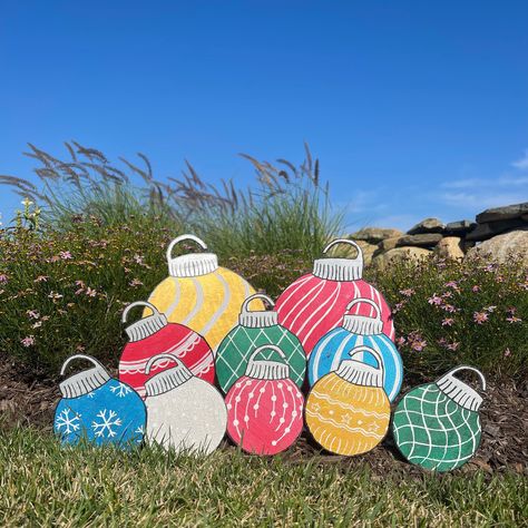 Merry Christmas! This is a pack of 10 wooden cutout ornaments ranging in different sizes and all having a unique hand-painted decoration. In this pack there are 2 large ornaments, 3 medium, and 5 small. These ornament cutouts are hand-painted and coated with a protective enamel paint to ensure they are weather resistant. Each ornament also comes with a 6 inch nail stake for adhesion to the ground. Measurements can be seen below: 2 large ornament - 11 inches height and 9 inches width 3 Medium orn Christmas Outdoor Yard Decorations, Christmas Wooden Yard Art, Christmas Wooden Yard Decorations, Outdoor Ornaments Yard Decorations, Big Ornaments Diy, Christmas Cutouts Templates, Wood Cutouts Christmas, Outdoor Wooden Christmas Decorations, Wooden Christmas Yard Decorations