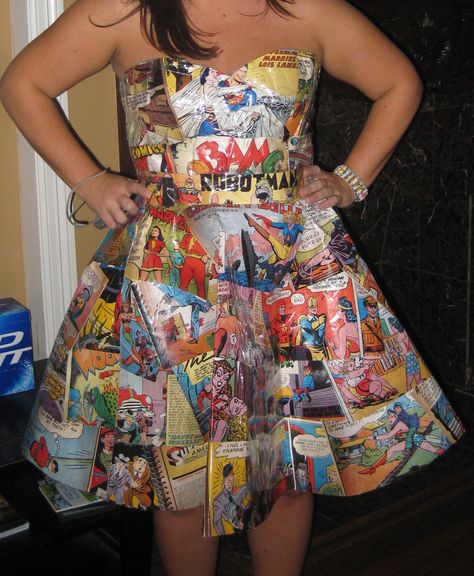 Comic pages repurposed into a full-skirted dress! Genius! This was my favorite costume of the weekend. This handmade 50s-style dress was assembled from comic book pages. A face-painted “Pow” and “Kaboom” headband completed the look. Clever, no? Comic Book Dress, Paper Skirt, Comic Wedding, Repurposed Fashion, Anything But Clothes, Comic Book Girl, Recycled Dress, 50s Fashion Dresses, Clothing Crafts