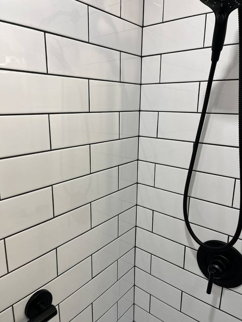 We love how this clients bathroom came out! The white subway tile is such a classic look, but the black grout lines and fixtures give it a bold & modern feel. #transitionaldesign #longislandcontractor #bathroomremodel Black Grout Bathroom, Bathroom With White Subway Tile, Tiles Black Grout, White Tiles Black Grout, Black Grout, White Subway Tile, Subway Tile, Grout, Transitional Design