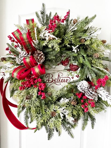 Christmas Wreath, Holiday Wreath, Winter Wreath, Red Bird Wreath, Farmhouse Wreath, Wreath with Cardinals, Front Door Wreath< Farmhouse Decor, Christmas Decoration, Holiday Decor, Decorating Idea, Christmas Gift for Her Be the envy of all your friends with this big beautiful wreath as part of your! This wreath is made on a 18" evergreen wreath base. Loads of Hemlock, cedar with pine cones, and snow covered cedar make this one full, fluffy and very real looking. The red berries make it pop and look great with the beautiful farmhouse "Believe" sign. Snow covered pine cones really give it that farmhouse feel. The beautiful is hand tied with designer ribbon, and completes the look for this one.  I recommend this one be displayed inside over a mantel, or on a door that is covered. Also, know th Wreath With Poinsettias, Christmas Cardinal Wreath, Xmas Wreaths For Front Door, Real Christmas Wreath, Wreath With Cardinals, Wreath With Birds, Real Christmas Wreaths, Red Bird Wreath, Designer Wreaths