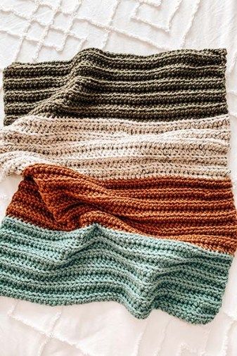 An image of a crochet baby blanket with colour stripes. Green, off white, orange and baby blue on a white bed. Crochet Blanket For Beginners Tutorials, First Crochet Blanket, Crochet Blanket 4 Colors, Crochet Swatch Blanket, 3 Colored Crochet Blanket, Beginner Crochet Baby Blankets, Crochet Blanket Patterns Simple, Gender Neutral Knit Baby Blanket, Free Baby Boy Crochet Blanket