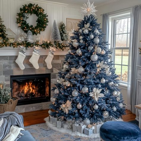 Transform your living room with a blue Christmas tree adorned with silver and white ornaments. Cozy accents like garlands, fairy lights, and a fireplace complete the holiday look. Blue Christmas Lights On Tree, Blue Silver And White Christmas Tree, Silver And White Christmas Tree, Christmas Lights On Tree, Blue Christmas Trees, Blue Christmas Lights, Tree Decorations Diy, Flocked Christmas Tree, Christmas Tree Decorating Ideas