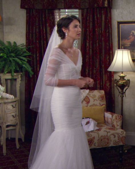 Monique Lhuillier made the lovely tulle mermaid gown that Robin (Cobie Smulders) wore for her walk down the aisle. "The reason we ended up with the dress that we did was because our director Pam Fryman wanted to reveal that it was Robin in a close-up and so many wedding dresses are strapless," said costume designer Reiko Kurumada. "In the close-up I didn't want it to look like Robin was nude. I really wanted a wedding dress that had beautiful detail on the shoulder, arm area." Tv Wedding Dresses, Movie Wedding Dresses, Famous Wedding Dresses, Worst Wedding Dress, Tv Weddings, Favorite Tv Characters, Cobie Smulders, Broken Dreams, Iconic Weddings