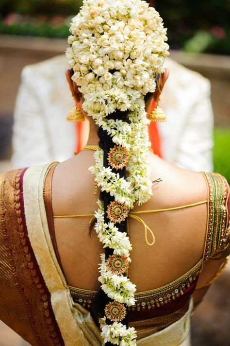 .The South Indian Bride with Mogra Flowers Beautifully done in her hair. #MystiqueWeddingStories Hairstyle With Jasmine, Bridal Hairstyle Indian Wedding, Ben Johnson, Bridal Hairdo, Saree Bollywood, Indian Wedding Hairstyles, Hairdo Wedding, South Indian Bride Hairstyle, Indian Bride Hairstyle