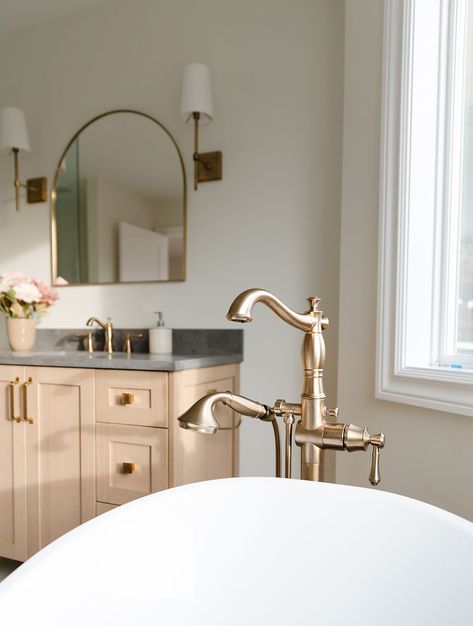 Champagne bronze details like the shower handle, hinges, and floor-mounted tub filler add an elegant touch. Delta Champagne Bronze Bathroom, Champagne Bronze Bathroom, Herringbone Tile Floors, French Villa, Bronze Bathroom, Herringbone Tile, Champagne Bronze, Tile Floors, Tub Filler