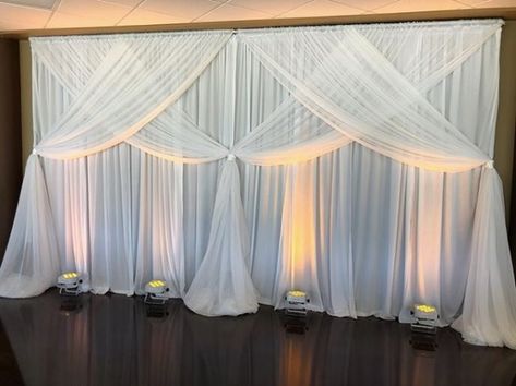 Uplighting on White Pipe and Drape for a local wedding at Valor Hall Conference and Event Center in Oak Grove, KY #wedding #pipeanddrape #uplighting Wall Draping Decor, Wedding Wall Draping, Draping Backdrop Ideas, Wall Draping Wedding, Event Center Design, Draping Wedding Reception, Pipe And Drape Wedding, Wedding Draping Backdrop, Wall Draping