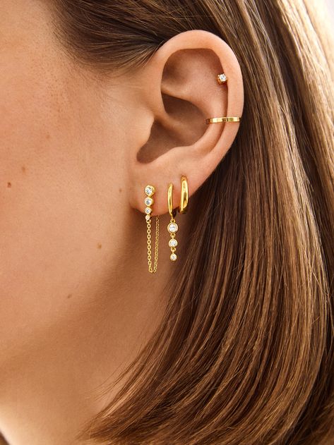 Introducing our Jenelle 18k Gold Earring Set – three times the charm in one stylish set. Choose between dainty drop earrings, delicate huggies with a shimmering drop accent, and a timeless huggie. Wear them all together or mix and match depending on your everyday mood. Either way, you’re set for years of style, thanks to its 18K gold plated sterling silver and Cubic Zirconia stones.