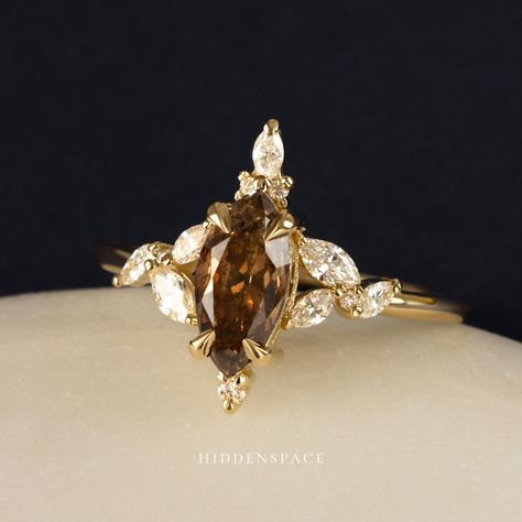 PSA! Your options aren't limited to just round white diamonds for April. Consider this gorgeous champagne salt & pepper diamond with a marquise cut on our Orabelle Ring! 𝐃𝐞𝐬𝐢𝐠𝐧𝐞𝐝 𝐟𝐨𝐫 𝐭𝐡𝐞 𝐌𝐨𝐝𝐞𝐫𝐧 𝐌𝐮𝐬𝐞 #hiddenspacejewelry #psa #birthstone #aprilbaby #champagnediamond #browndiamond #saltandpepperdiamondring #uniqueengagementring #diamondalternative #artdecojewelry Brown Diamond Ring Engagement, Brown Engagement Ring, Brown Engagement Rings, Brown Diamond Engagement Ring, Engagement Wishes, Brown Diamond Ring, Big Wedding Rings, Salt Pepper Diamond, Marquise Diamond Ring