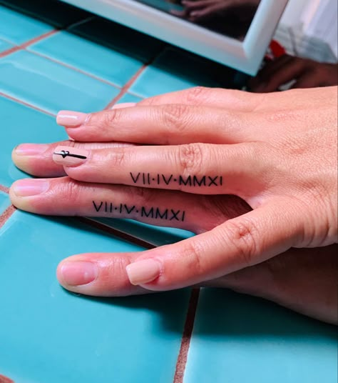 Roman numeral anniverary finger tattoo Coordinates Tattoo Finger, Roman Numeral Finger Tattoo Wedding Ring, Ring Finger Roman Numeral Tattoo, Finger Tattoo Roman Numerals, Roman Numeral Tattoo Ring Finger, Roman Numeral Tattoo On Finger, Roman Numerals Finger Tattoo, Ring Finger Tattoo Couple Name, Finger Roman Numeral Tattoo